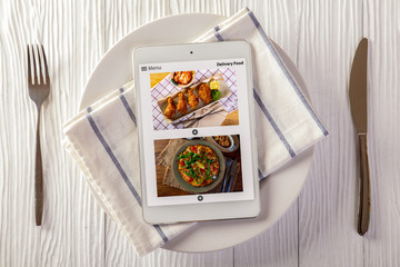 Food delivery concept with a digital tablet