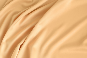 Close up of ripples in gold colored silk fabric. Satin textile background. Free copy space.