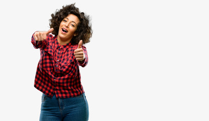 Obraz premium Beautiful arab woman stand happy and positive with thumbs up approving with a big smile expressing okay gesture
