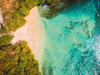 Aerial view of tropical beach with crystal turquoise ocean in Bali, holiday beach
