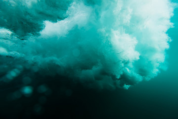 Fototapeta na wymiar Wave texture in underwater. Wave crashing on shore