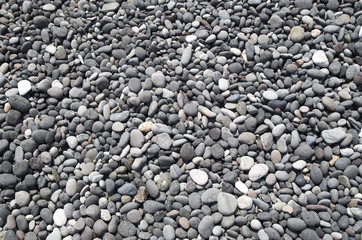 Gray and black pebbles on beach