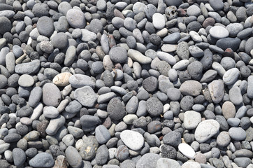 Gray and black pebbles on beach