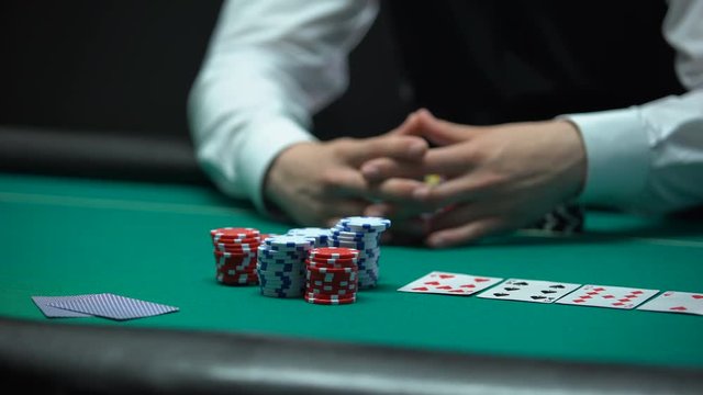Risky poker player going all-in, betting money and house keys, addiction