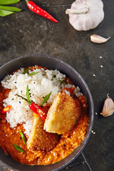 Hot Spicy Crispy Fried Chicken Fillet with Curry and Rice on Dark Background