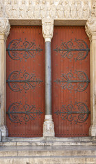 The ancient wooden door on church in France