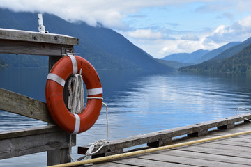 Orange buoy in front of lake with mountains