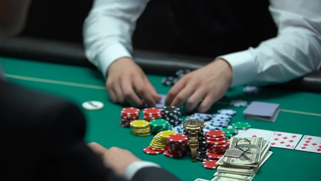 Addicted poker player going all-in, betting chips, money and property, reckless