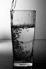 Water pouring into the clear glass