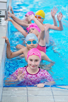 happy kids at the swimming pool. young and successful swimmers pose.