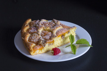 Homemade organic apricot pie dessert ready to eat . Apricot tart with walnut on black background