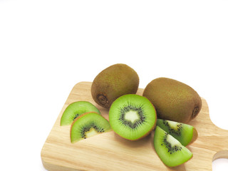 Slice of fresh juicy delicious and healthy kiwi fruit on wooden chopping board, isolated on white background.