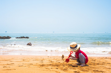 Baby girl play with sand 