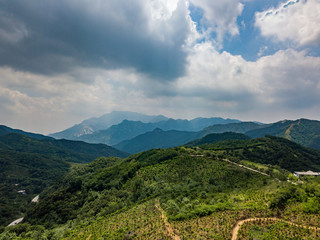 Far view of Mount Tai in summer time, with its peak was surrounded by cloud 