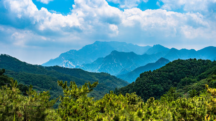 Far view of Mount Tai in summer time, with its peak was surrounded by cloud 