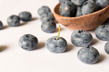 Fresh blueberries in a wooden spoon on a white background. Close up. The concept of natural food