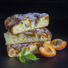 Homemade organic apricot pie dessert ready to eat . Apricot tart with walnut on black background