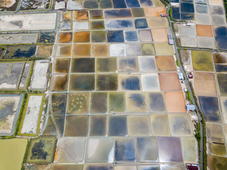 Aerial view of saline pond and salt evaporation ponds filled from ocean salt crystals  have...