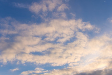 Spring blue sky with a few clouds . On a blue background