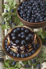 Pancakes with blueberry jam and blueberries .