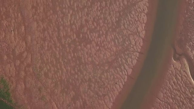 Close up shot of the sandy patches in the ocean off of the shores of Lympstone England. Some water grass is visible, and areas where the water is deeper.