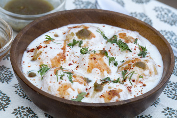 Dahi Vada or Dahi Bhalla are fried lentil dumplings, topped with curd, sweet and green chutney and spices.