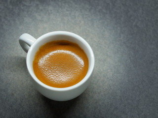 Cup of Espresso coffee on board background, Arabica with crema