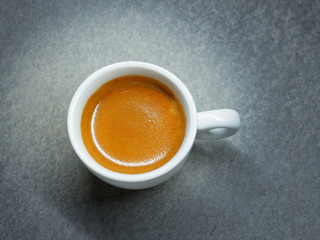 Cup of Espresso coffee on board background, Arabica with crema