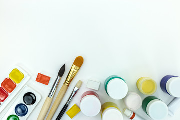 Obraz premium bright colored paints and set of brushes on white background. school painter tools flat view