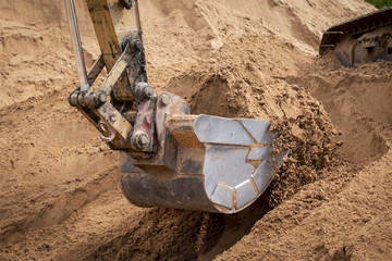construction machinery at the construction site of the road in the quarry is gaining ground and...