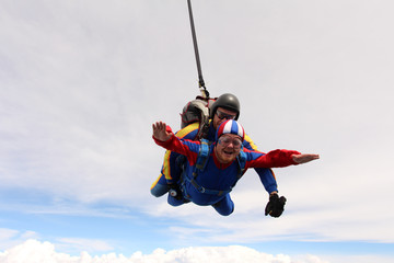 Tandem skydiving. Two men are in the sky.