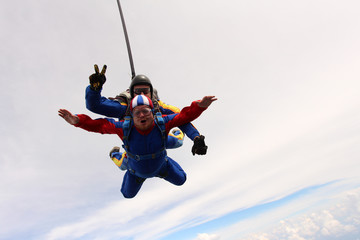 Tandem skydiving. Two men are in the sky.