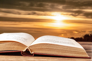 Open book against a beautiful sunset