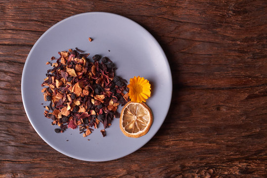 Dry Fruit Tea Flower And Lemon On Plate. Nice Red Wood Table. Concept Of Health Food