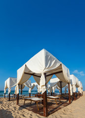 Beach canopies on white sandy beach