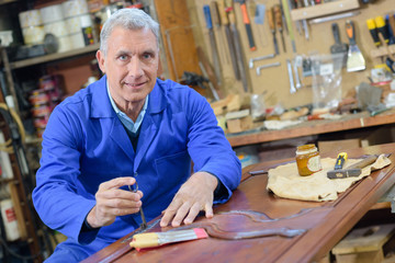 an elderly carpenter at work