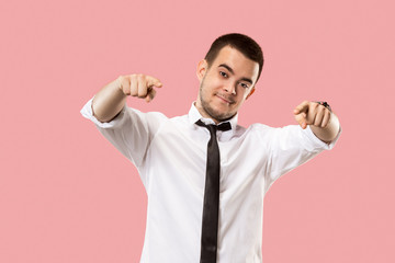 The overbearing businessman point you and want you, half length closeup portrait on pink background.