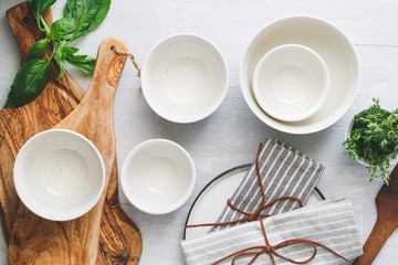 Kitchen utensils on a white table in a modern kitchen. Place for text. Top view.