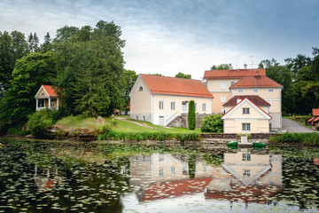 Fototapeta na wymiar An old manor house Vihula in Estonia, Lahemaa park. Beautiful summer landscape with pond