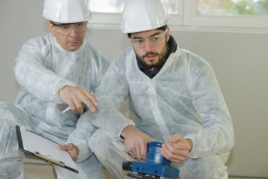 Plasterer With Power Sander