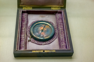 Vintage analogue metal compass in a box on table