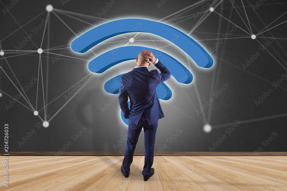 Poster businessman in front of a wall with wifi symbol displayed on a futuristic interface - connection and