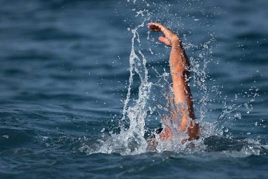 Man swimmer swimming crawl in blue sea,training for triathlon