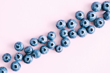 Berry background. Fresh berry blueberries on a pink background. Concept of healthy and dieting eating. Flat lay, top view, copy space 
