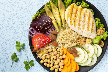 Bowl of Buddha, The concept of a healthy diet: grilled chicken, avocado, chickpeas, kinua, carrots,...