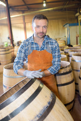 wood barrels production cooper using hammer and tools in workshop © auremar