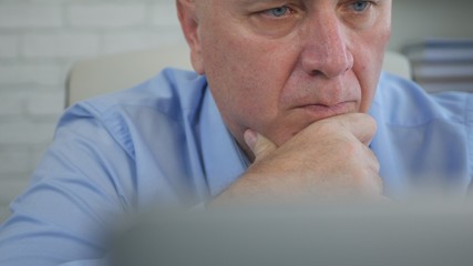Preoccupied and Confident Businessman Working With Laptop in Office Room