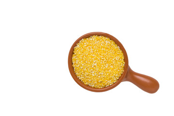 Crushed corn groats in a bowl isolated on white background. © magic_rainbow