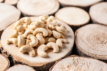 Tasty cashew nuts on wooden stump