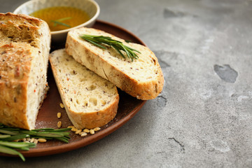 Plate with fresh tasty bread and oil on table